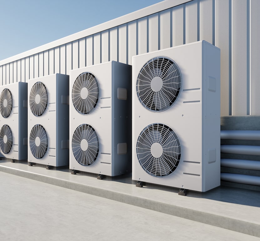 Image of 4 HVAC units on top of a commercial building, a total of 8 large fans between them