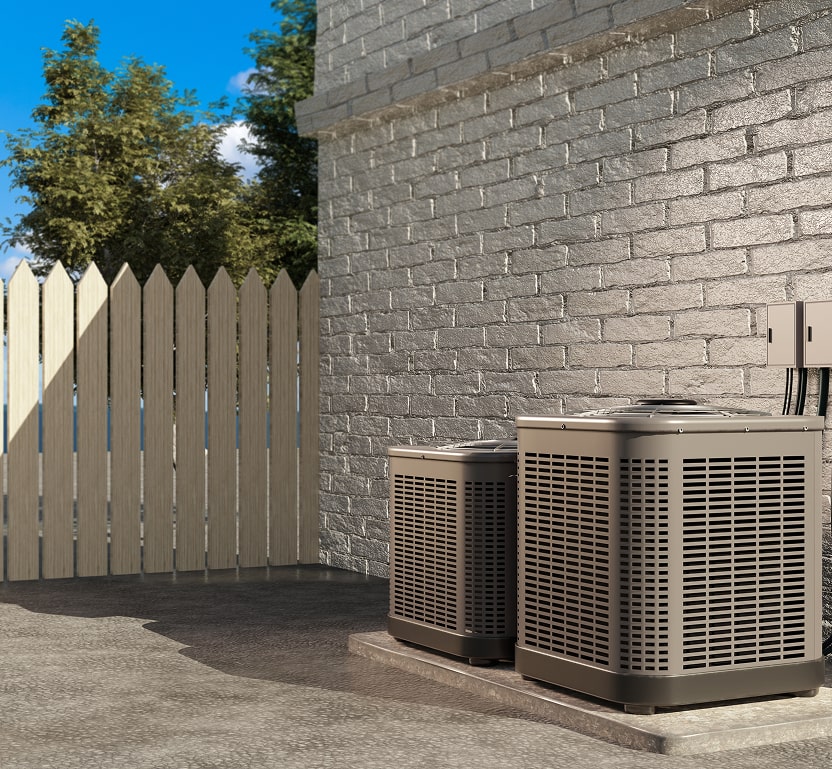 2 Outdoor units can be seen near a brickwall near a fence.